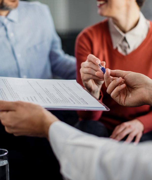 closeup-unrecognizable-couple-signing-contract-with-financial-advisor (1)